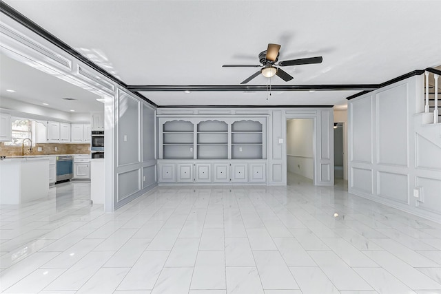 unfurnished living room with crown molding, sink, built in features, and ceiling fan