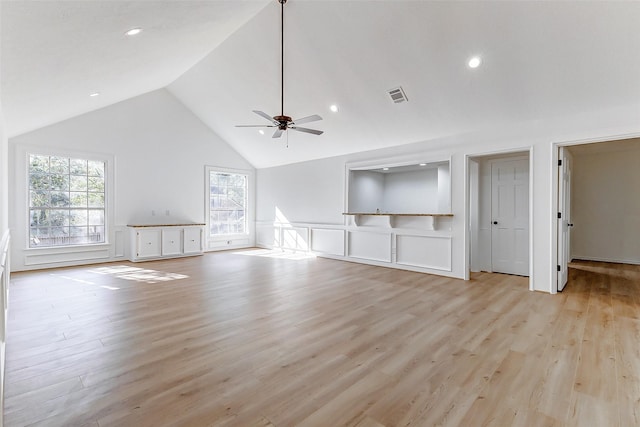 unfurnished living room with ceiling fan, high vaulted ceiling, and light wood-type flooring