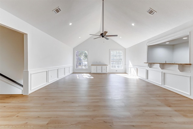 unfurnished living room featuring high vaulted ceiling, ceiling fan, and light wood-type flooring