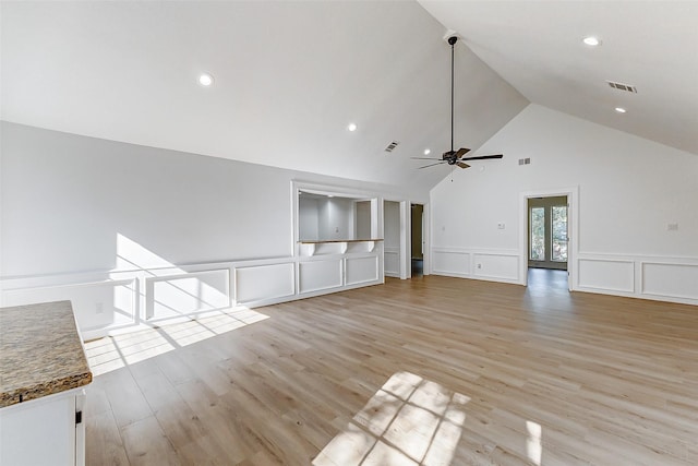 unfurnished living room featuring high vaulted ceiling, light hardwood / wood-style floors, and ceiling fan