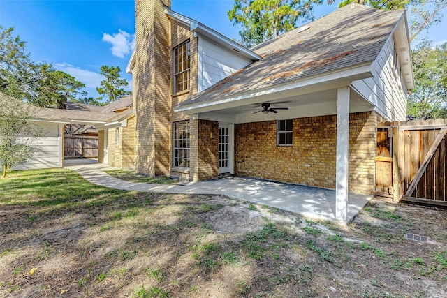 rear view of house featuring ceiling fan and a patio area