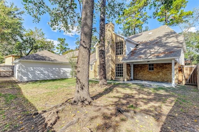 rear view of property with a yard and a patio