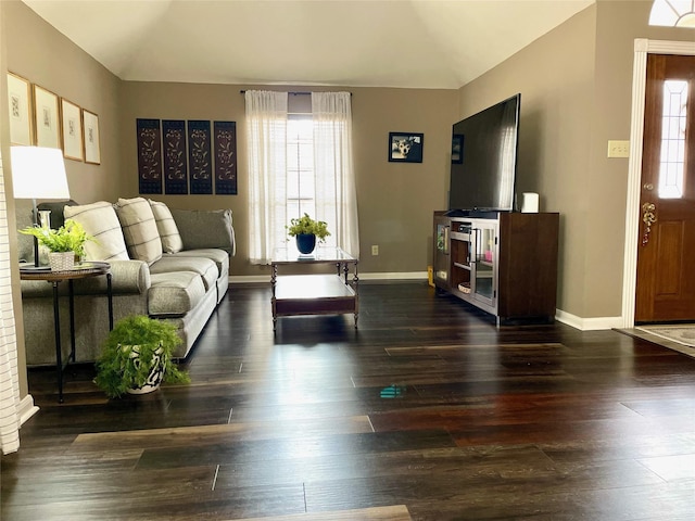 living room with lofted ceiling, dark hardwood / wood-style floors, and a wealth of natural light