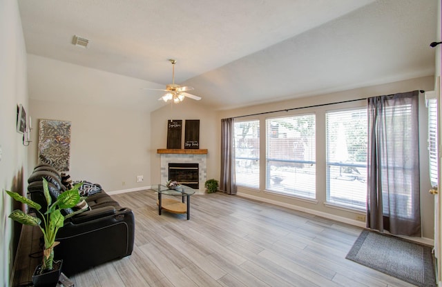 living room featuring vaulted ceiling, ceiling fan, and light wood-type flooring