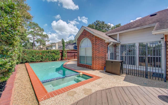 view of pool with an in ground hot tub