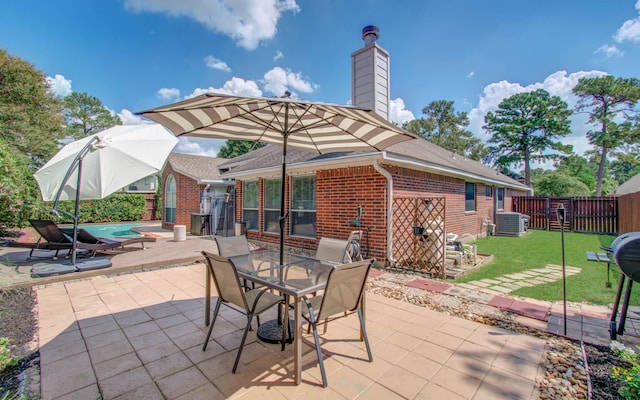 view of patio with central AC and a swimming pool