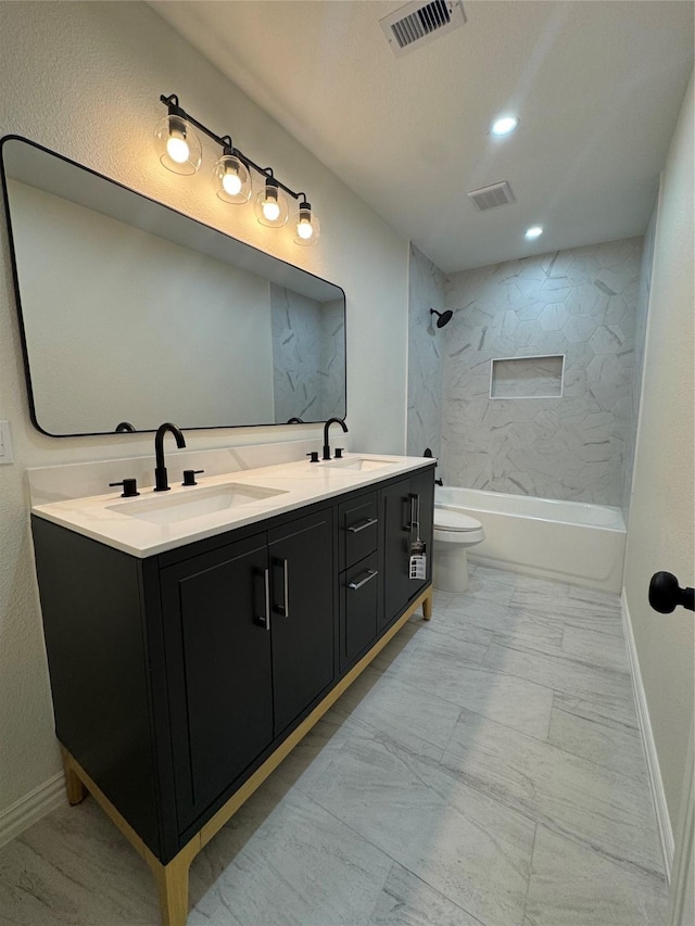 full bathroom with tiled shower / bath, vanity, and toilet