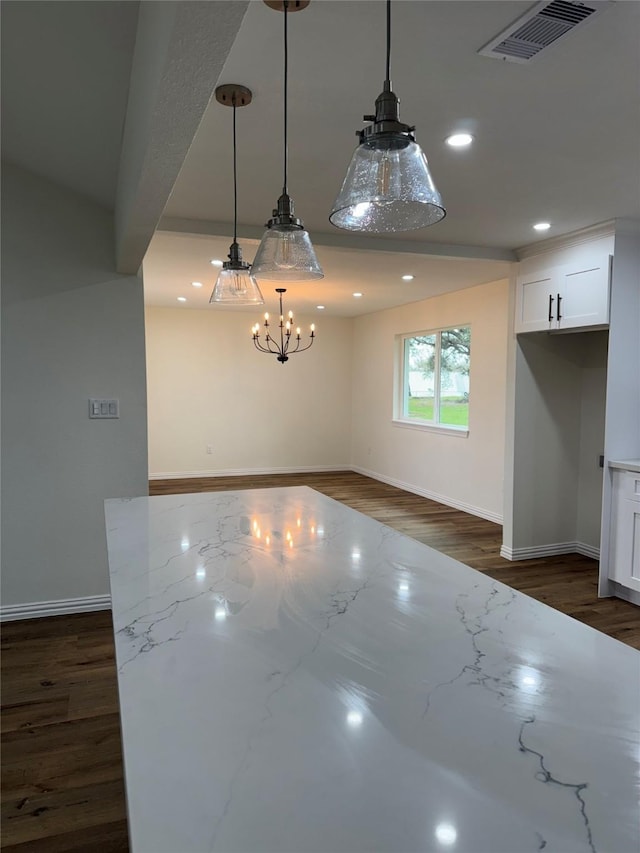 interior space with dark wood-type flooring and a chandelier