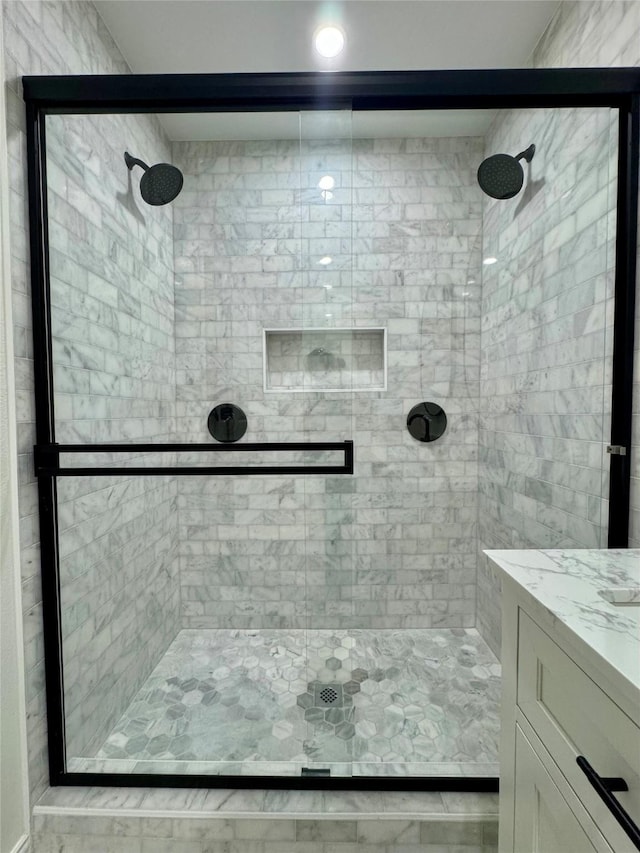 bathroom with vanity and walk in shower