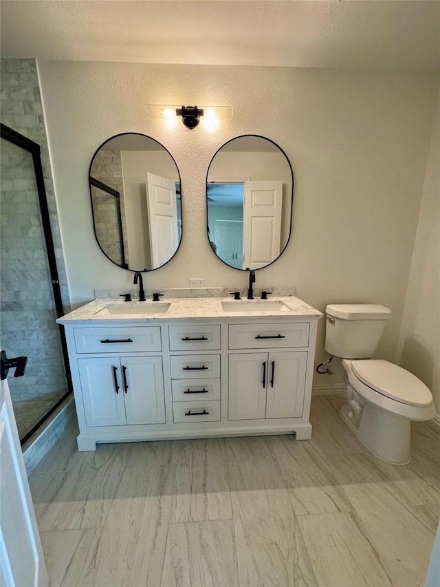 bathroom with vanity, an enclosed shower, and toilet