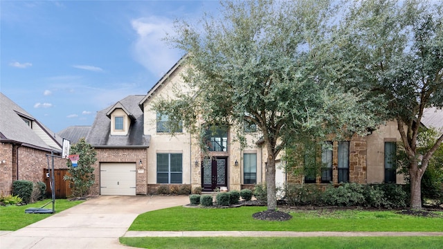 view of front of house featuring a garage and a front yard