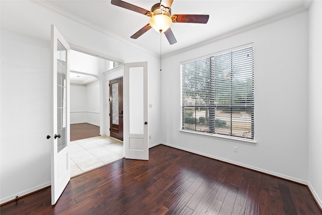 unfurnished bedroom with hardwood / wood-style flooring, ornamental molding, french doors, and ceiling fan