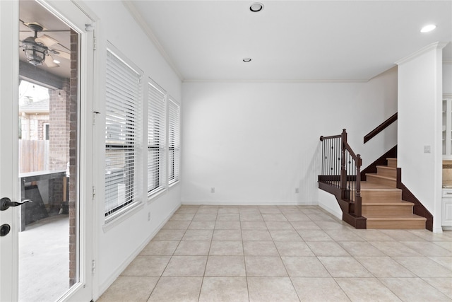 interior space with light tile patterned floors, ornamental molding, and ceiling fan