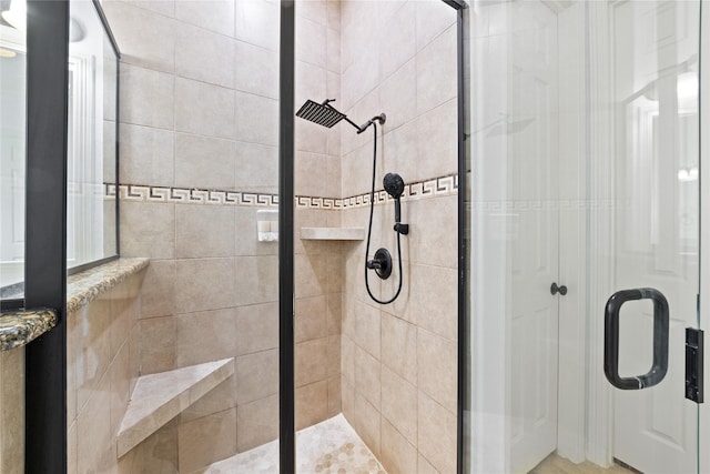 bathroom with a shower with shower door