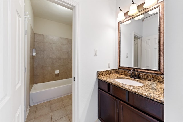 bathroom featuring tiled shower / bath, vanity, and tile patterned flooring