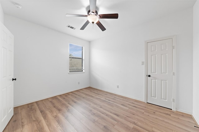 empty room featuring ceiling fan and light wood-type flooring