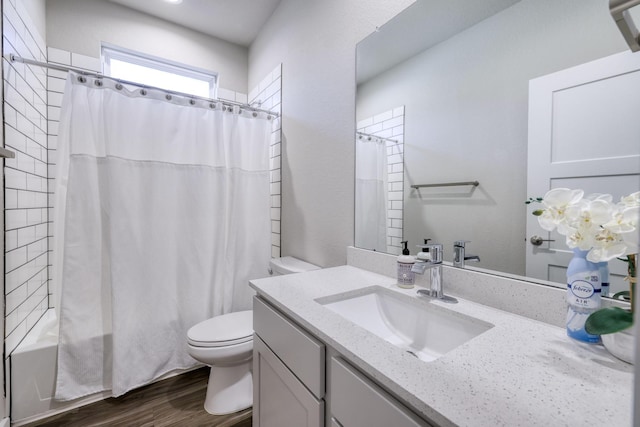 bathroom with toilet, shower / bath combination with curtain, wood finished floors, and vanity