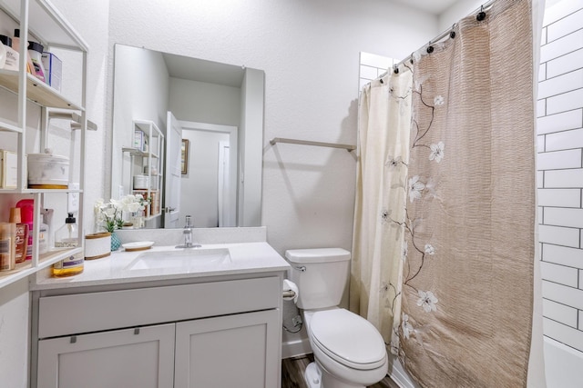 full bath featuring toilet and vanity