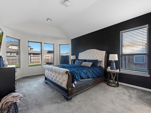 carpeted bedroom with lofted ceiling