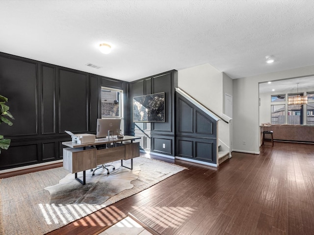 office with dark hardwood / wood-style floors and a textured ceiling