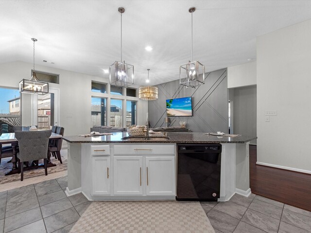 kitchen with sink, hanging light fixtures, black dishwasher, dark stone counters, and white cabinets