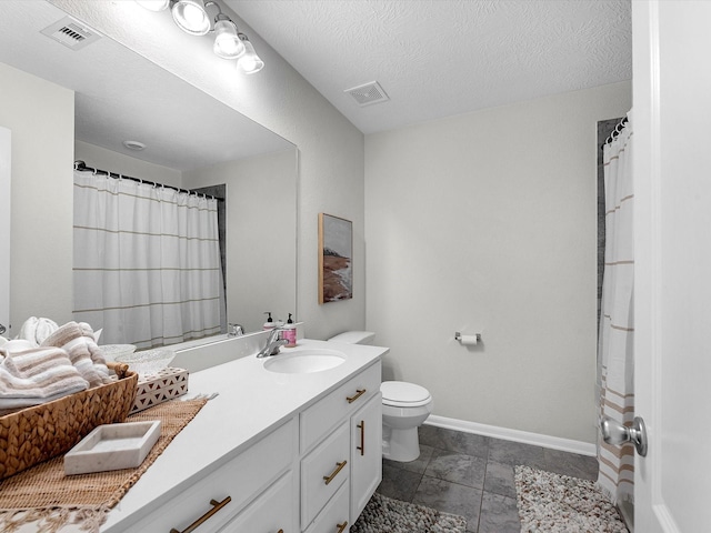 bathroom with vanity, a textured ceiling, and toilet