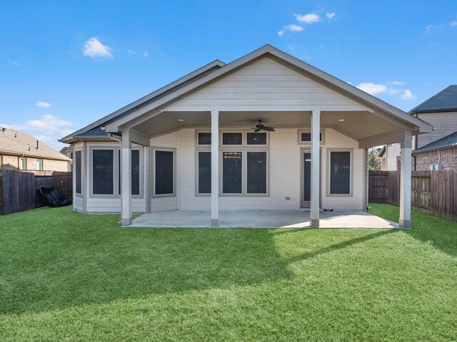 rear view of house featuring a lawn, ceiling fan, and a patio area