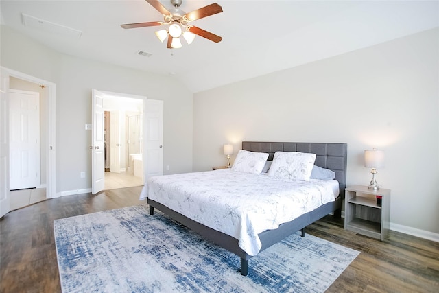 bedroom with lofted ceiling, ensuite bath, dark wood-type flooring, and ceiling fan