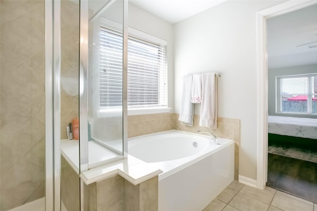 bathroom with separate shower and tub and tile patterned flooring