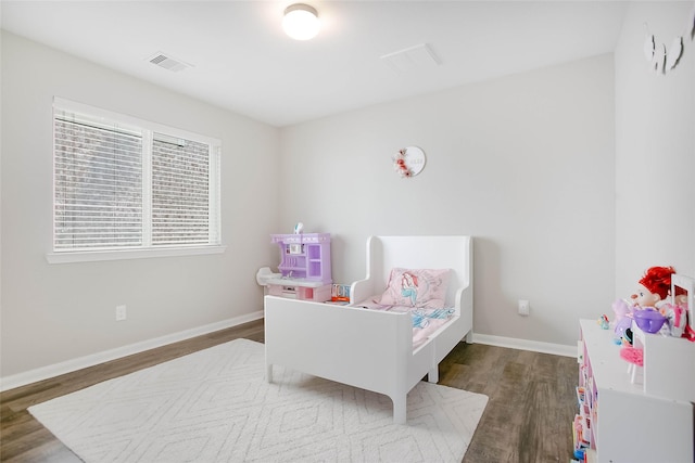 bedroom with dark wood-type flooring