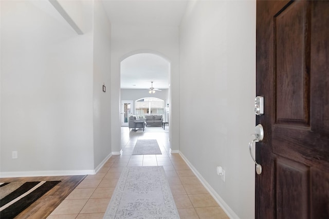 tiled foyer featuring ceiling fan