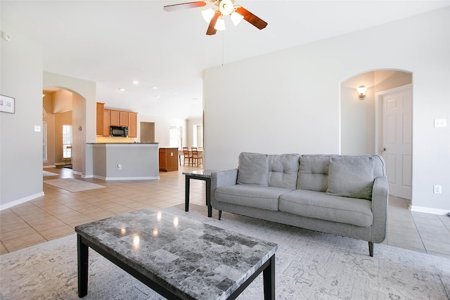 tiled living room featuring ceiling fan