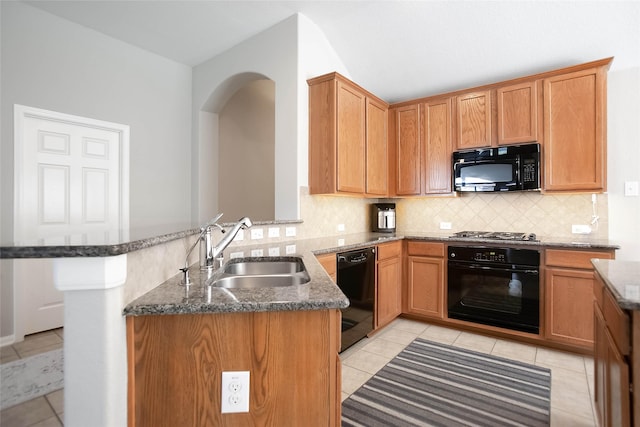 kitchen with sink, black appliances, kitchen peninsula, and stone counters