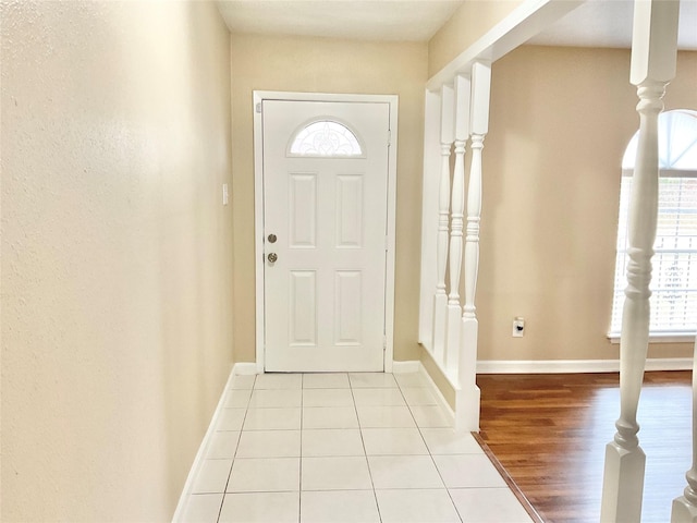 entryway featuring light tile patterned flooring and a wealth of natural light