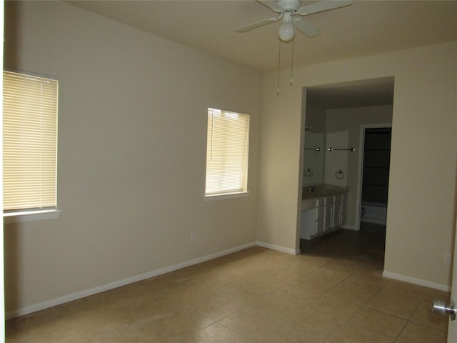 interior space with ensuite bathroom and light tile patterned floors