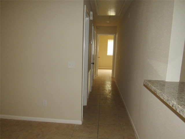 hallway with tile patterned floors