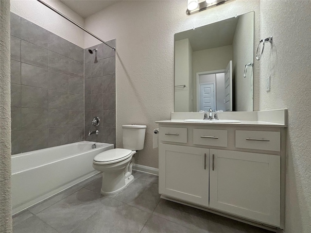 full bathroom with toilet, tile patterned flooring, vanity, and tiled shower / bath