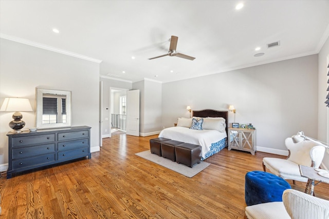 bedroom featuring crown molding, ceiling fan, and light hardwood / wood-style flooring