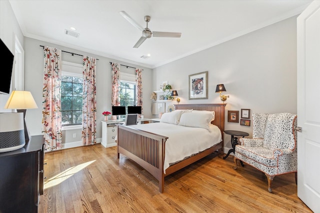 bedroom featuring crown molding, ceiling fan, and light hardwood / wood-style floors