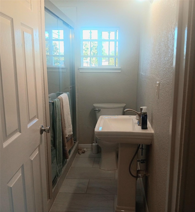 bathroom with tile patterned floors and toilet