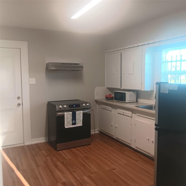 kitchen featuring stainless steel appliances, light hardwood / wood-style floors, and white cabinets