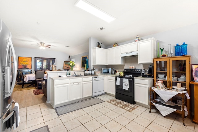 kitchen with white cabinetry, vaulted ceiling, light tile patterned floors, appliances with stainless steel finishes, and kitchen peninsula