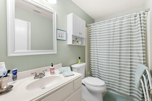 bathroom featuring vanity, a shower with curtain, and toilet