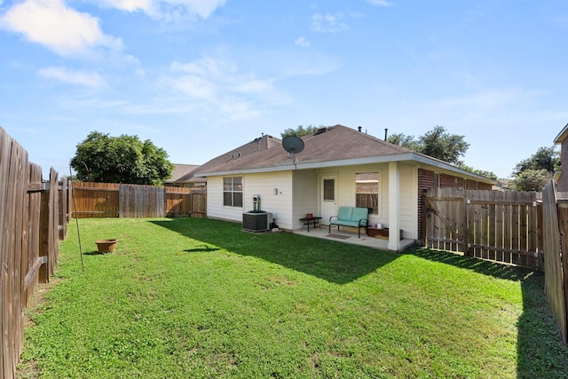 rear view of house with central AC unit, a patio area, and a lawn