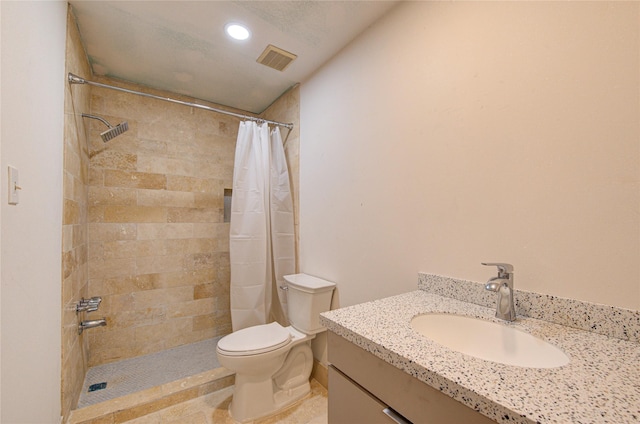 bathroom with a shower with curtain, vanity, and toilet