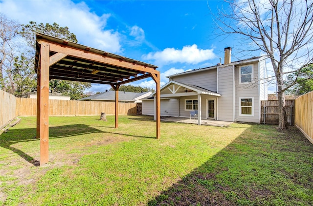 back of property featuring a yard and a patio