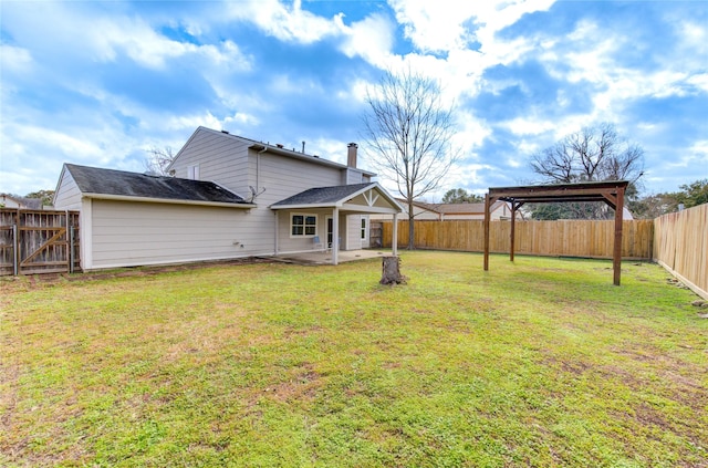 rear view of house with a gazebo, a patio area, and a lawn