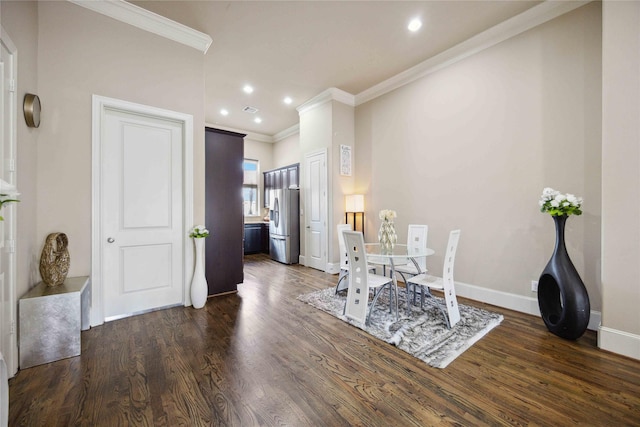 dining area with ornamental molding and dark wood-type flooring