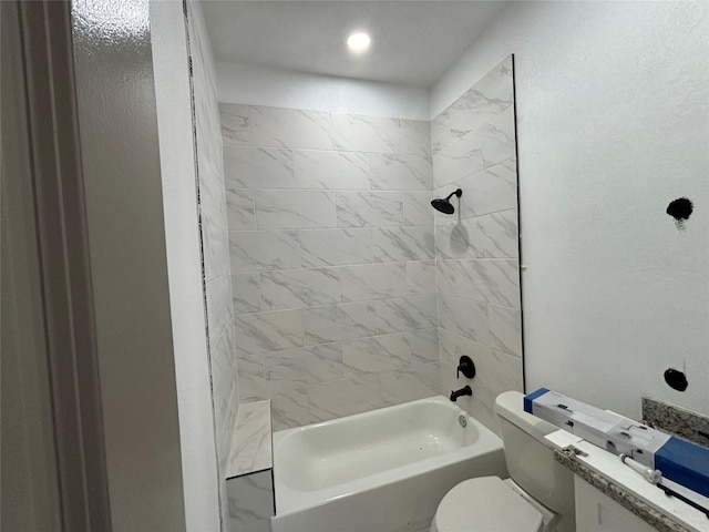 bathroom with tiled shower / bath combo and toilet