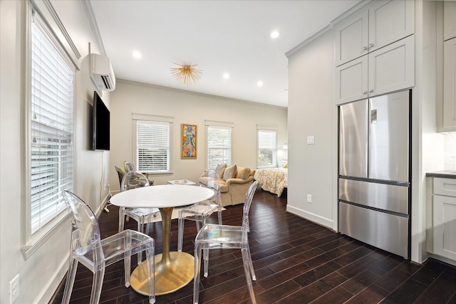 dining space featuring crown molding, an AC wall unit, and dark hardwood / wood-style floors